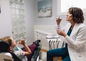 Photograph of dentist blowing bubbles